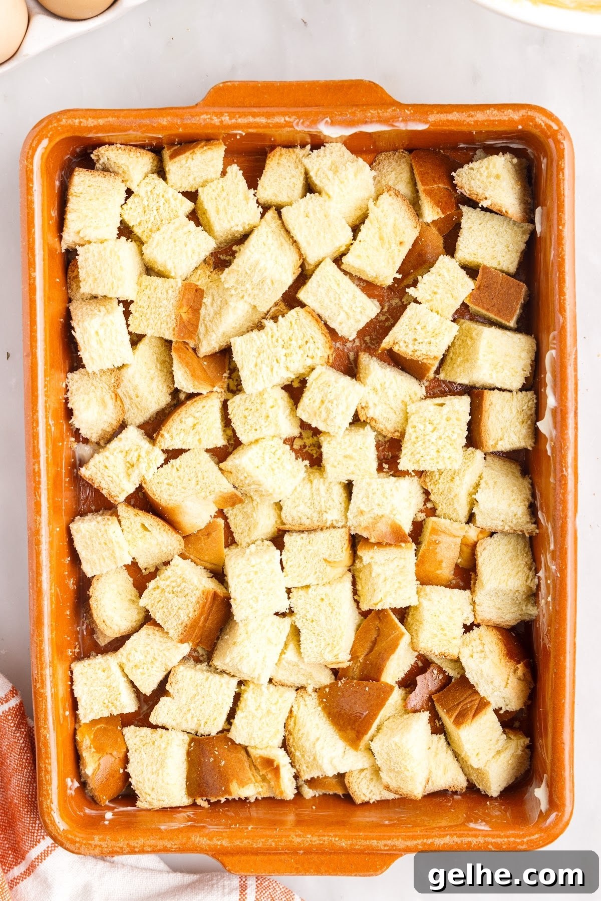 Place the bread cubes on the bottom of the prepared baking dish.