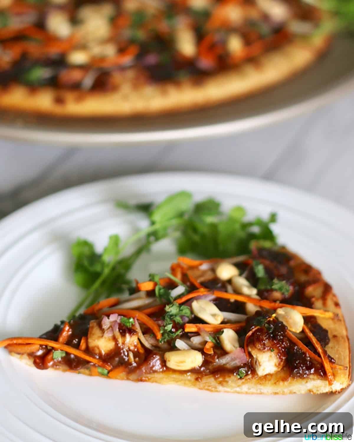 CPK Thai Chicken Pizza Copycat Recipe: Creamy Peanut & Sweet Chili 6 CPK Thai Chicken Pizza slice on white plate.