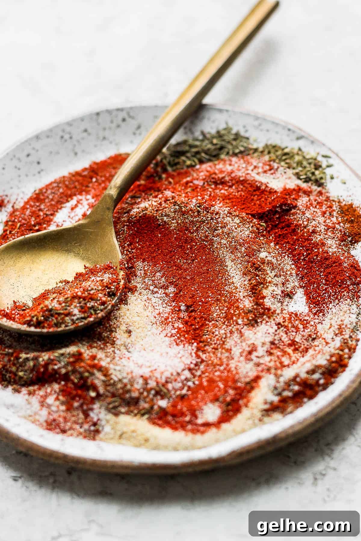 Savory Blackened Seasoning Blend for Fish, Chicken & Vegetables 2 Plate of blackened seasoning with gold spoon.