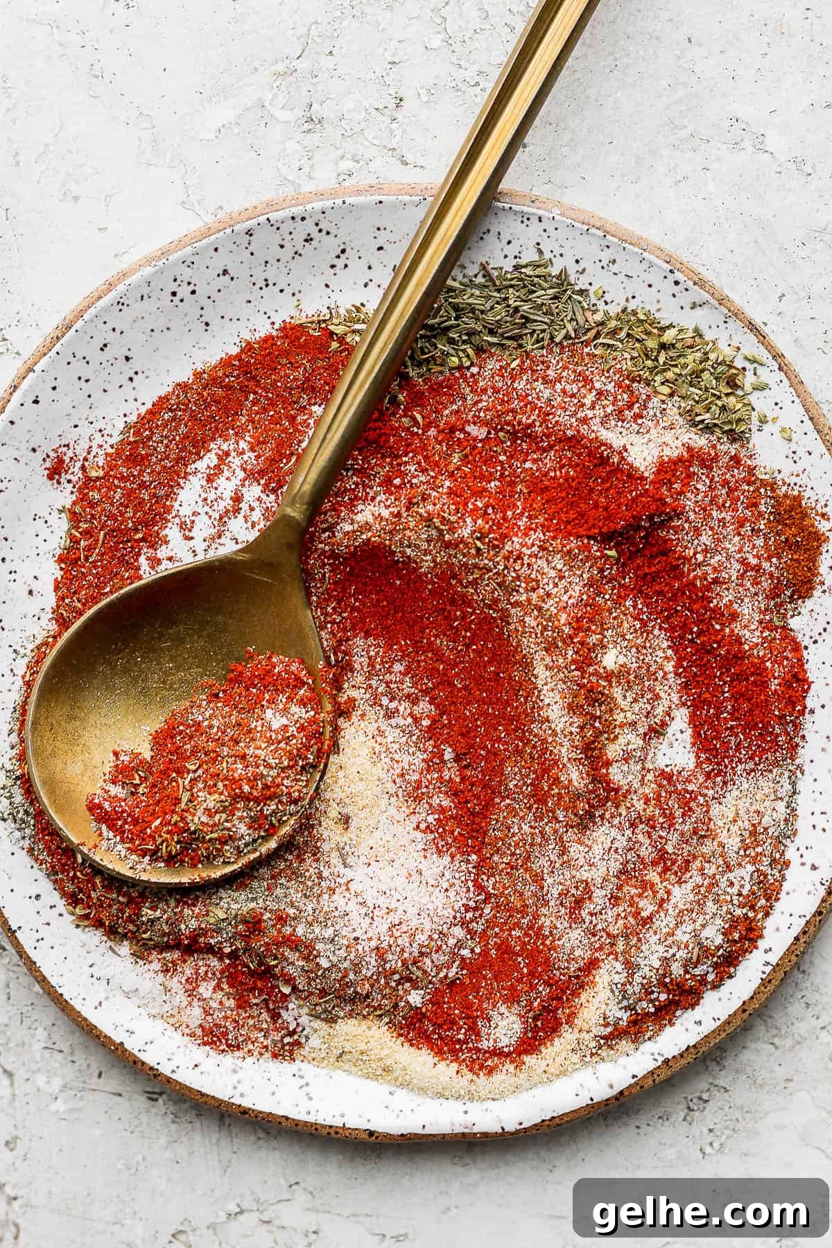 Savory Blackened Seasoning Blend for Fish, Chicken & Vegetables 3 Plate of blackened seasoning mixed together with gold spoon.