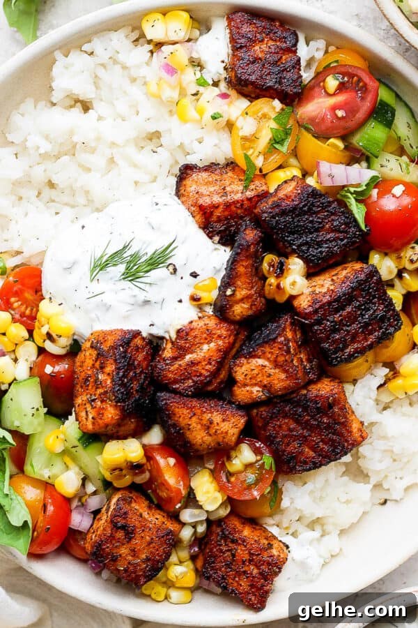 Savory Blackened Seasoning Blend for Fish, Chicken & Vegetables 8 Top down shot of a bowl with blackened salmon bites, dill sauce and grilled corn salad over rice.