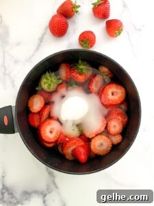 Strawberry with sugar in a saucepan.