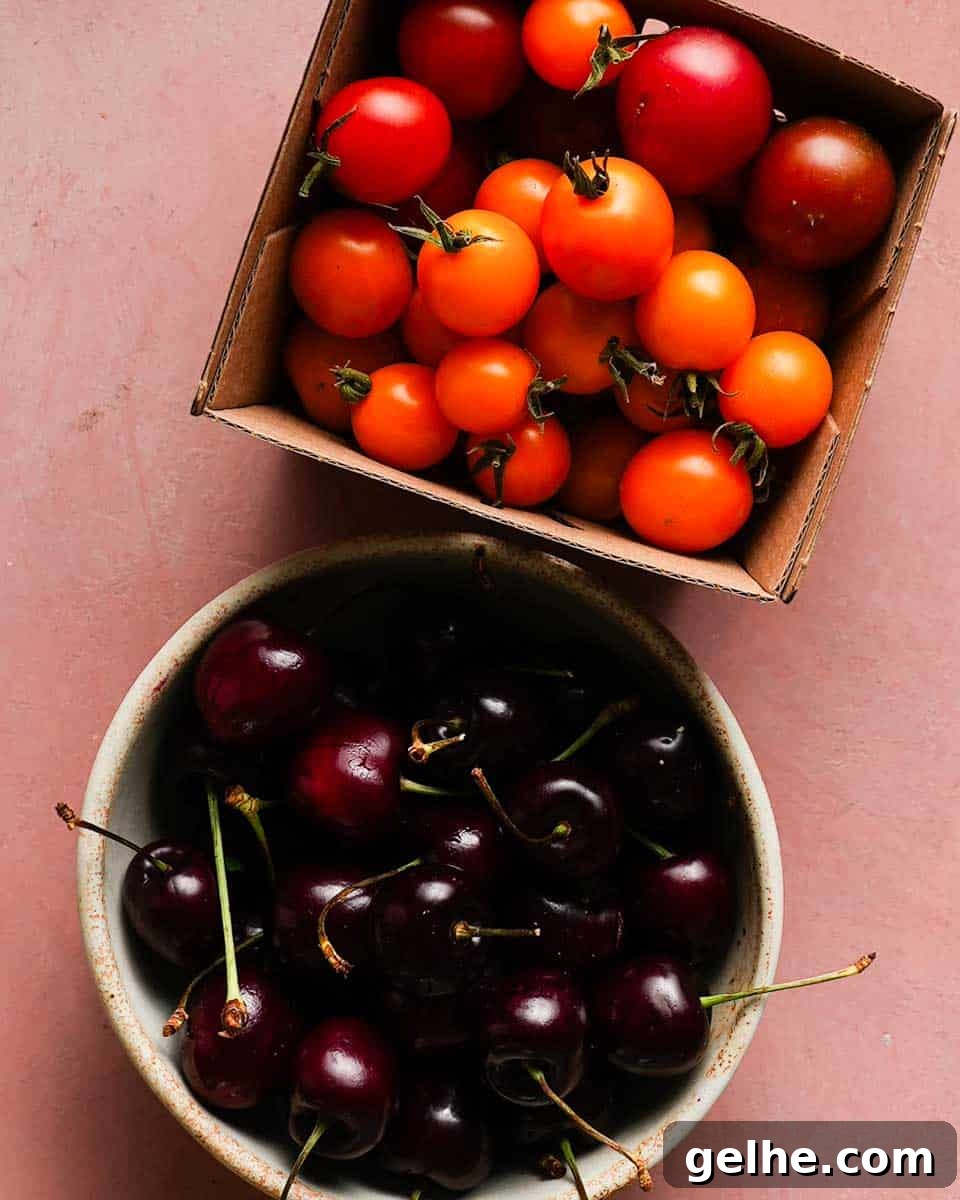 two containers; one containing fresh cherries and the other containing cheery tomatoes
