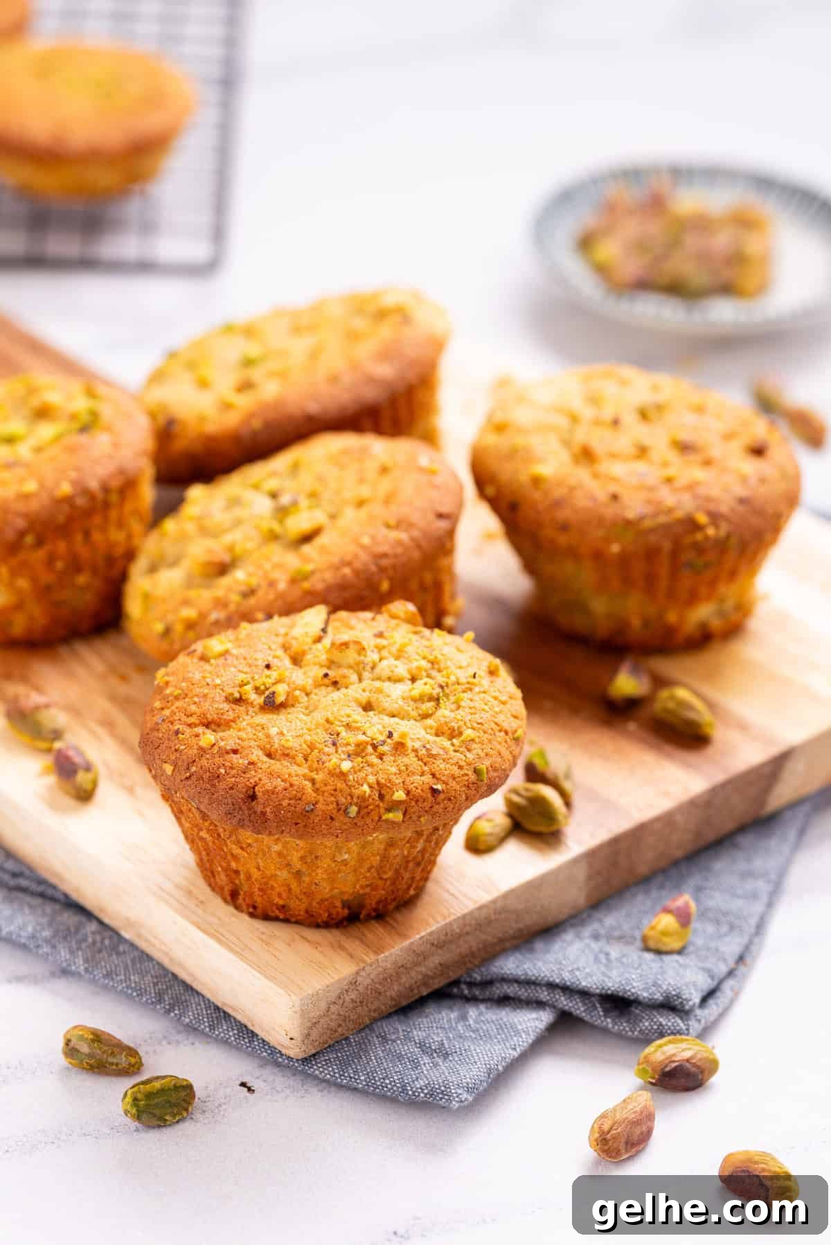 Homemade Pistachio Muffins Without Pudding Mix 2 A close up image of pistachio muffins on a serving board.