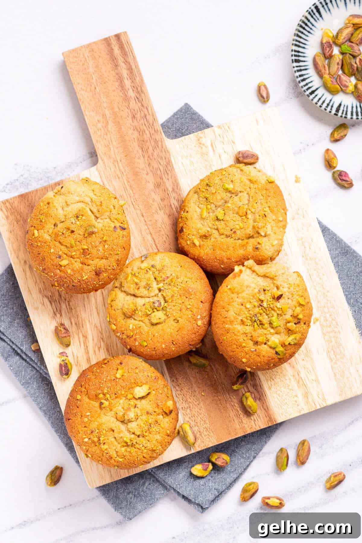 Homemade Pistachio Muffins Without Pudding Mix 11 An image of pistachio muffins on a serving board.