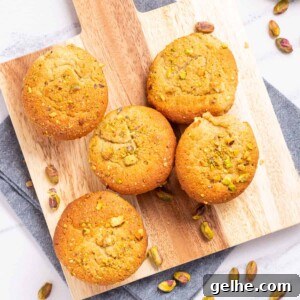 Homemade Pistachio Muffins Without Pudding Mix 13 An overhead image of pistachio muffins on a wooden serving board.