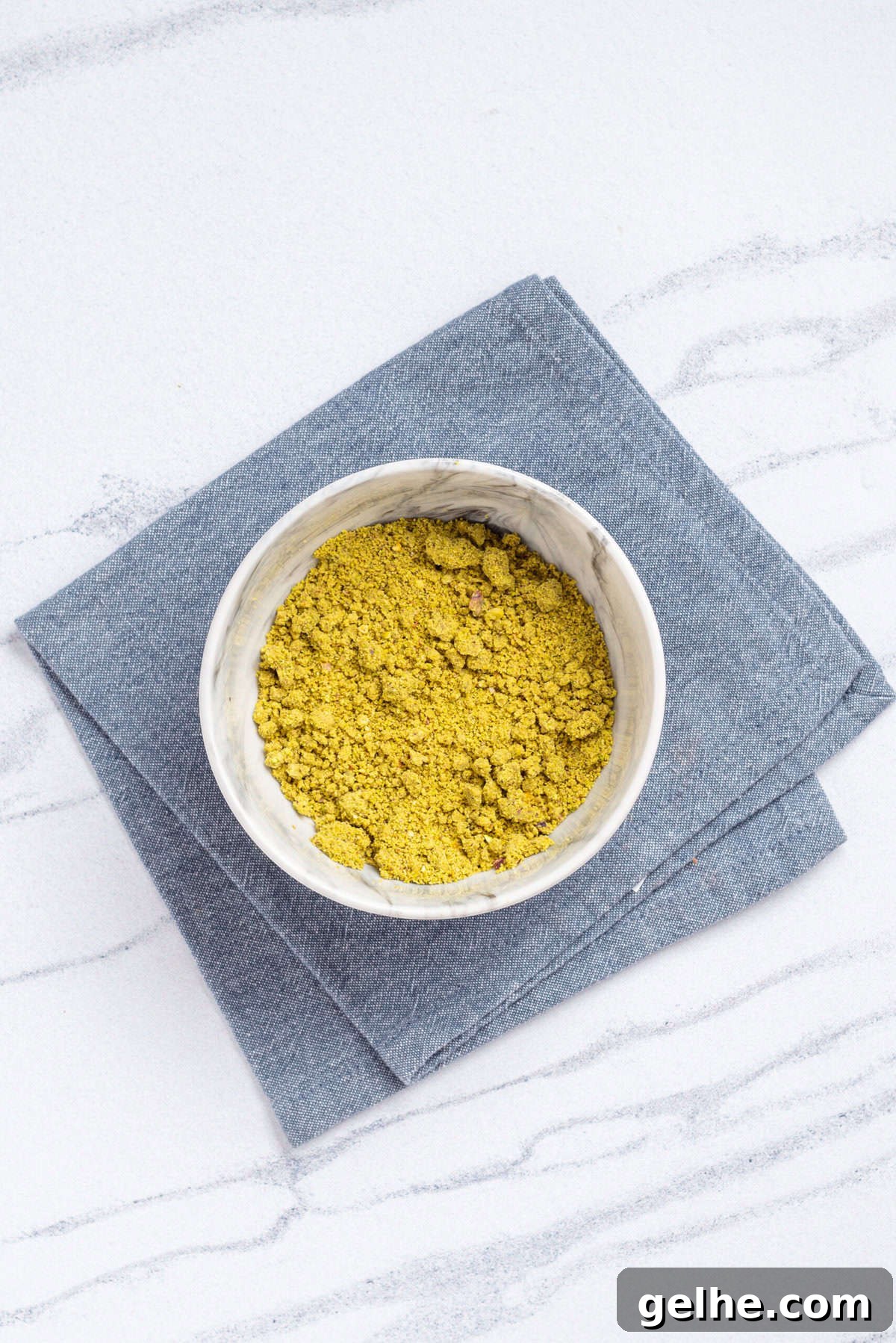 Homemade Pistachio Muffins Without Pudding Mix 6 An overhead image of ground pistachios.