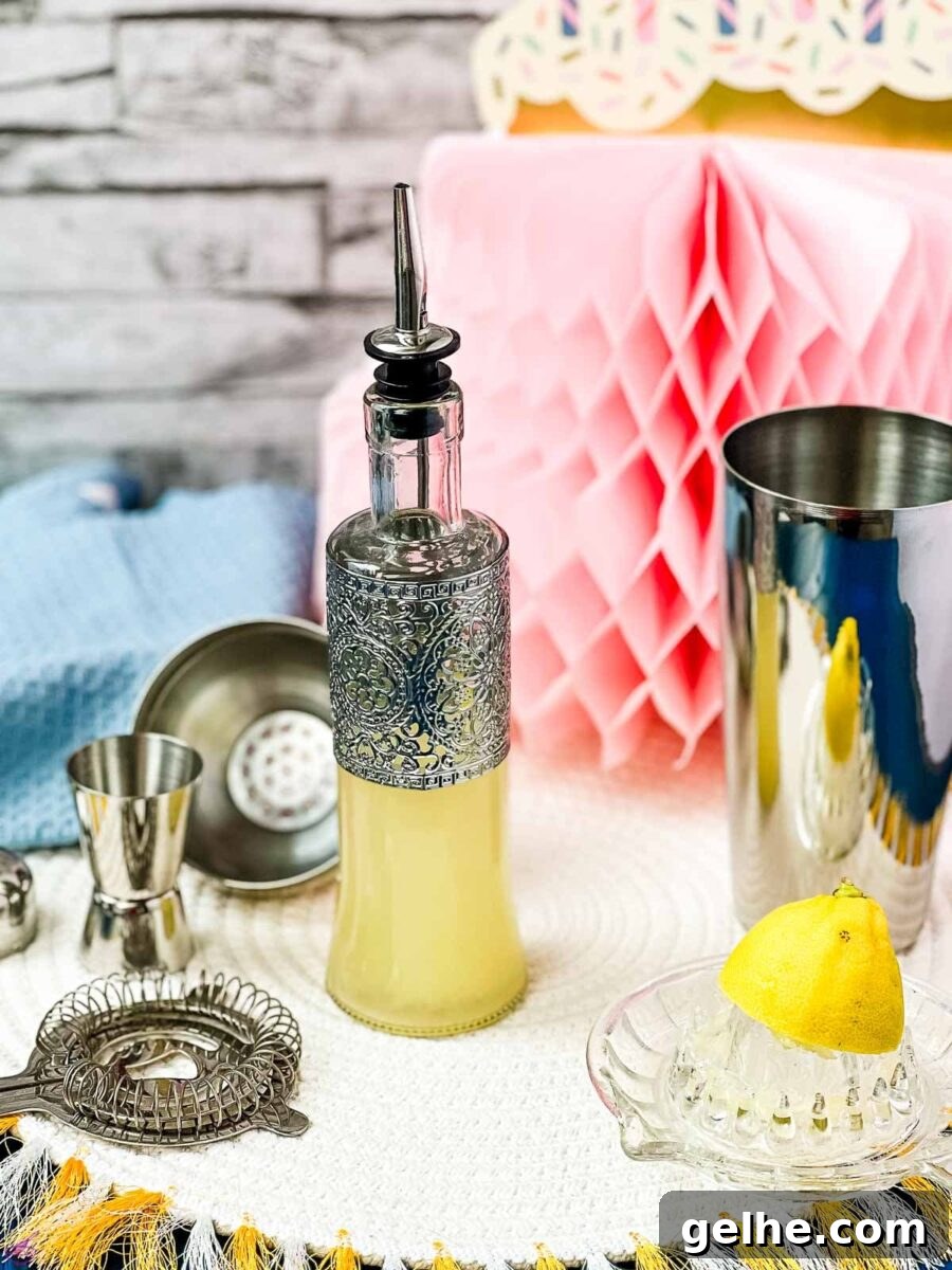 Fresh-Squeezed Lemon Juice: A Complete Guide to Making and Using It 6 Bottle filled with freshly squeezed lemon juice fitted with a pouring spout, surrounded by cocktail making tools.