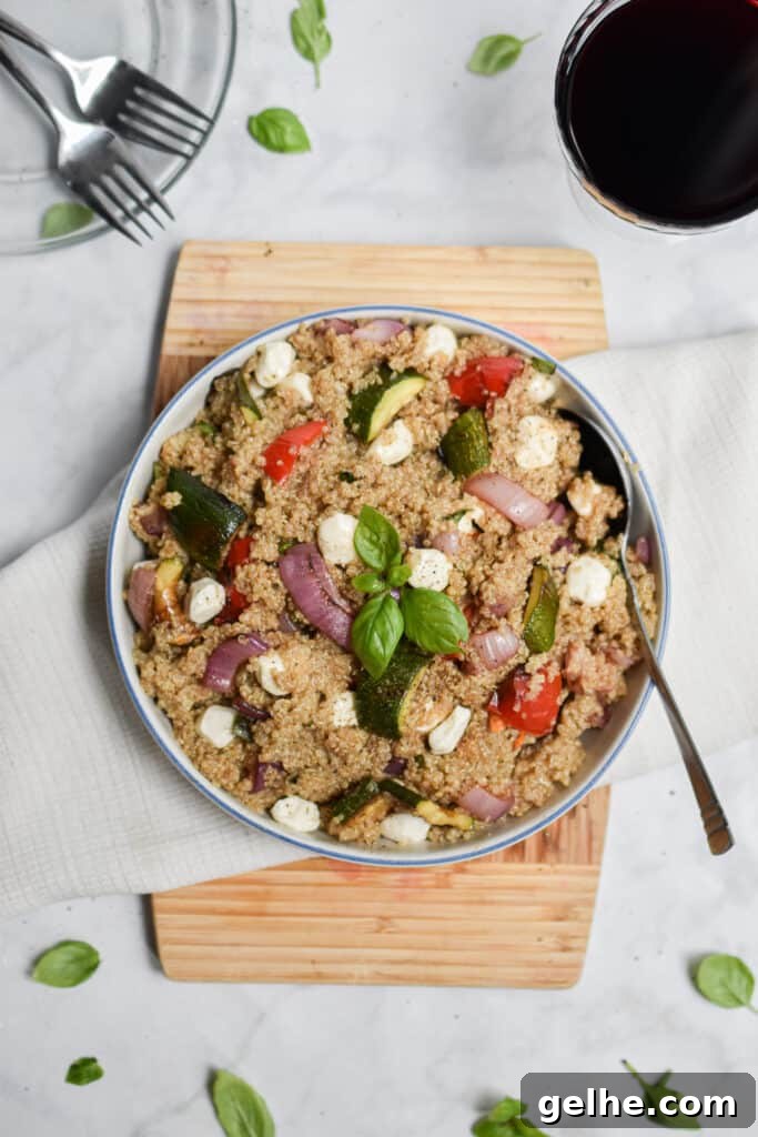 Grilled Vegetable and Quinoa Salad with Lemon Vinaigrette 9 the salad is on a cutting board with a plate and forks in the corner