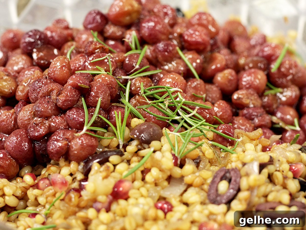 Roasted grapes in a wheat berry salad with rosemary on top.