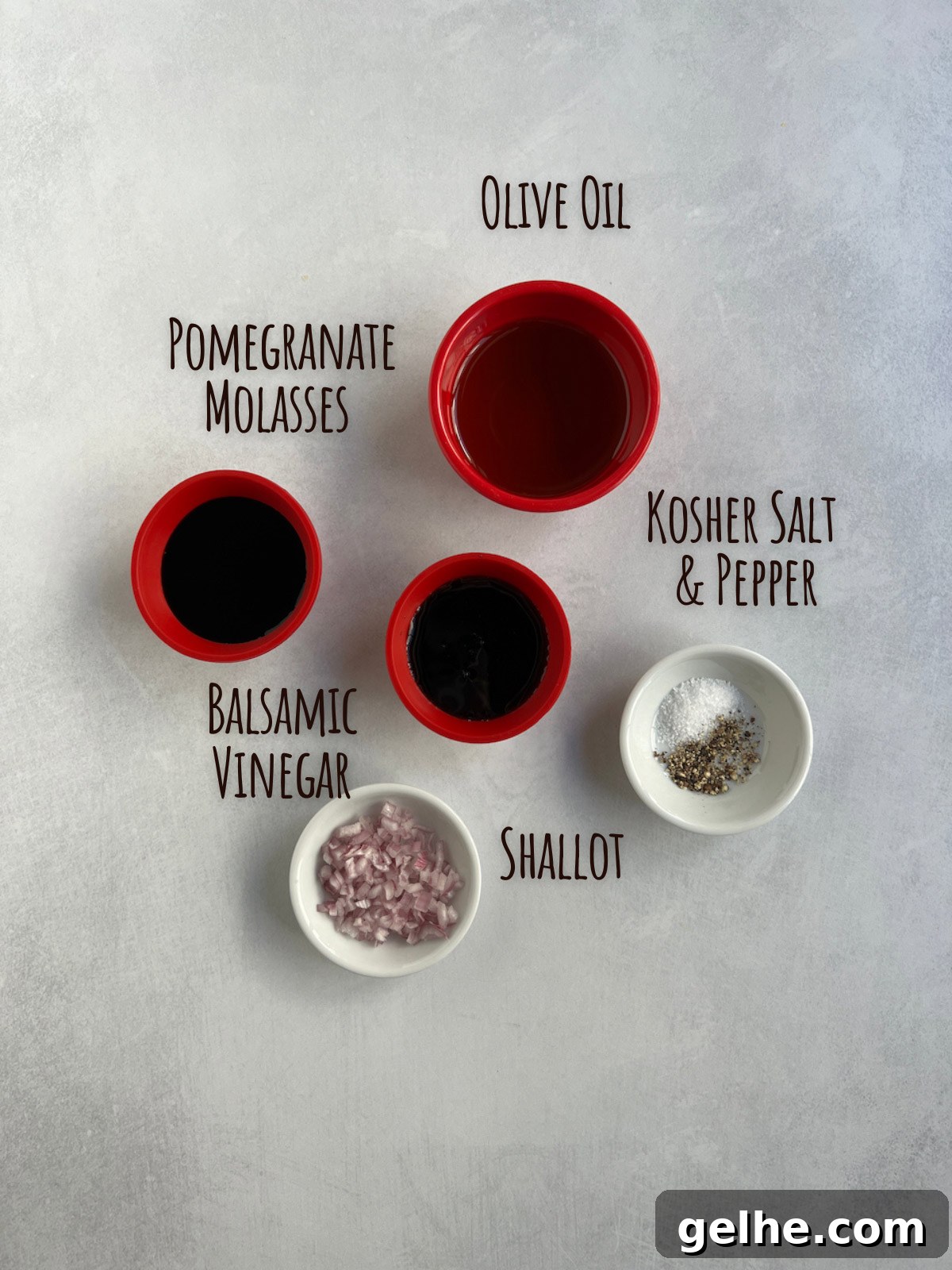 Ingredient shot for roasted grapes showing liquid ingredients plus salt and pepper and shallots.