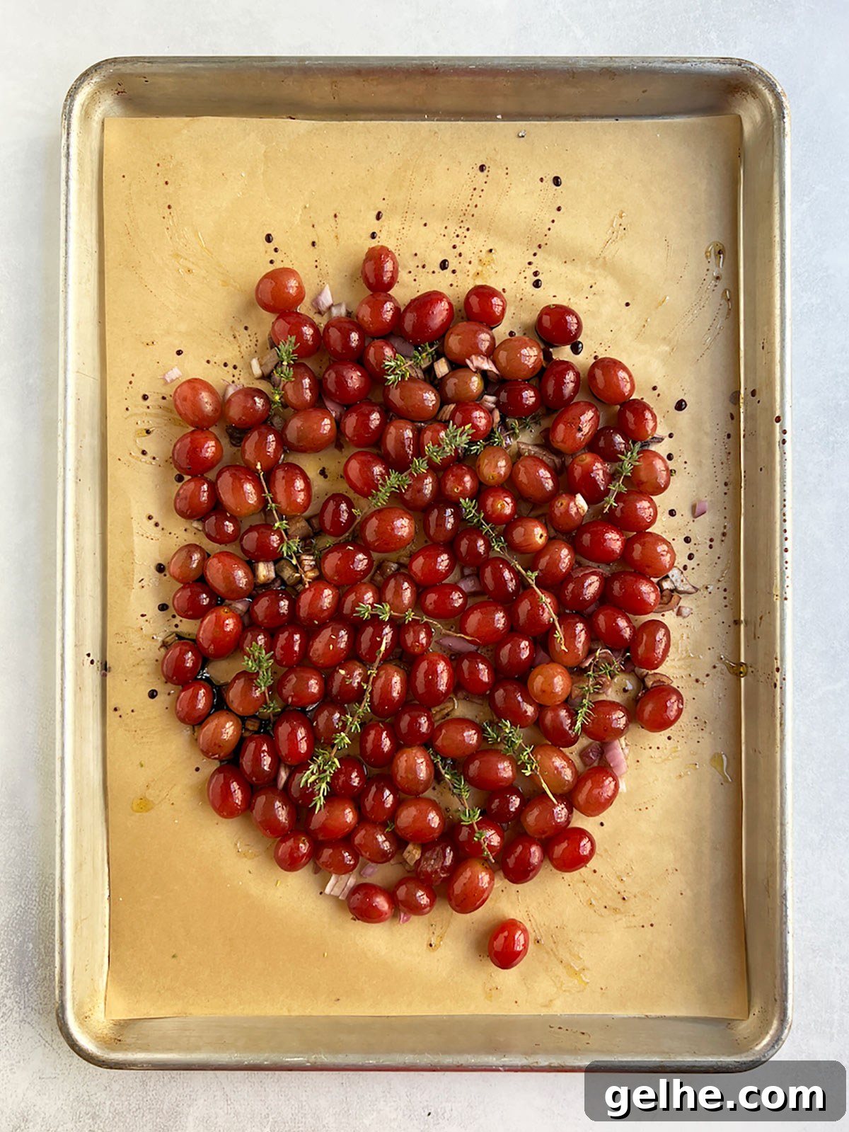 Grapes mixed with liquid and fresh thyme added.