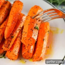 Air Fryer Carrots on plate with fork.