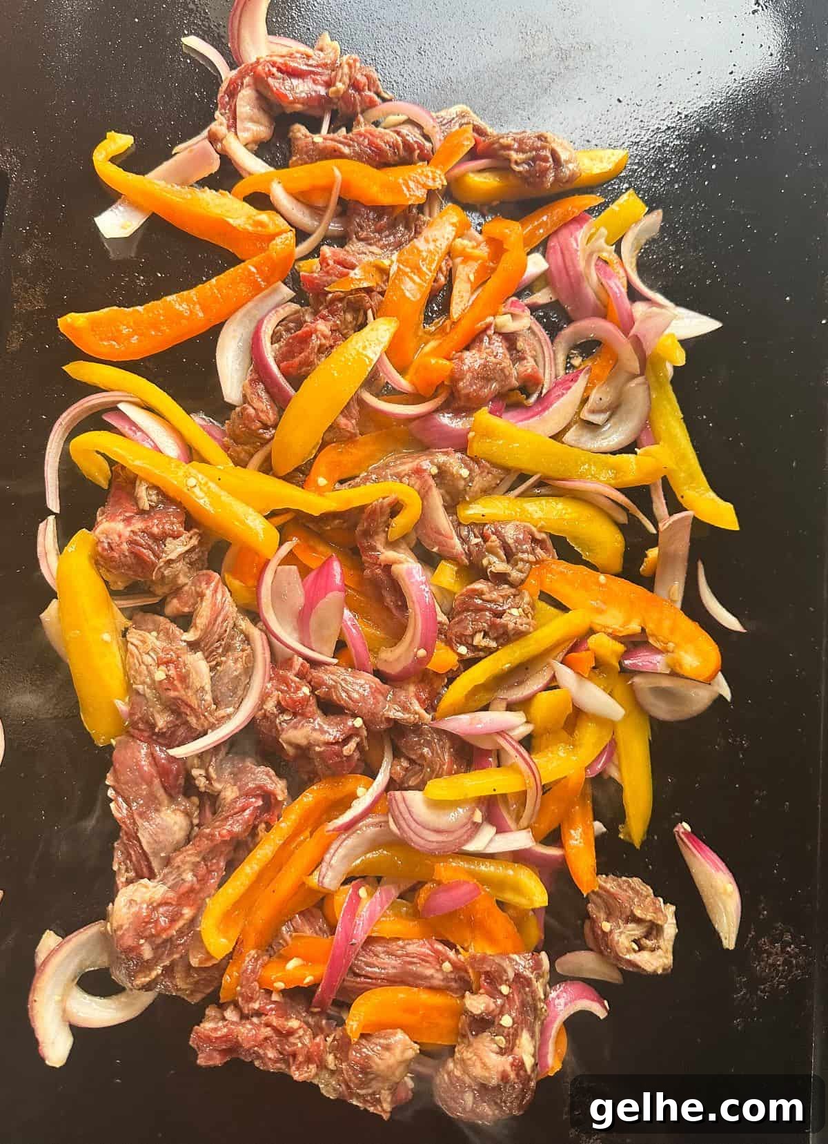 Flavor-Packed Skirt Steak Marinade for Juicy Fajitas 7 Fajita meat and peppers on griddle