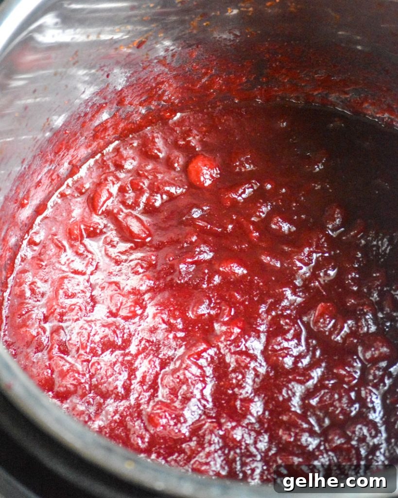 Quick Instant Pot Cranberry Sauce Recipe for Thanksgiving 5 Instant Pot cranberry sauce shown in the liner of the Instant Pot pressure cooker after cooking down