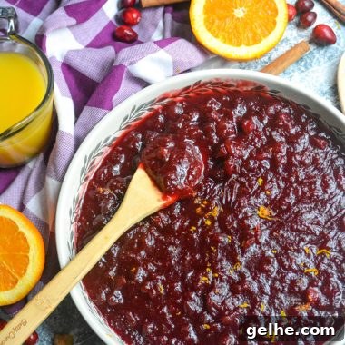 Quick Instant Pot Cranberry Sauce Recipe for Thanksgiving 8 Instant pot cranberry sauce shown in a large shallow white serving dish with a wooden spoon for serving