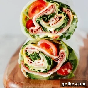 A lettuce wrap sandwich sitting on top of a wooden cutting board