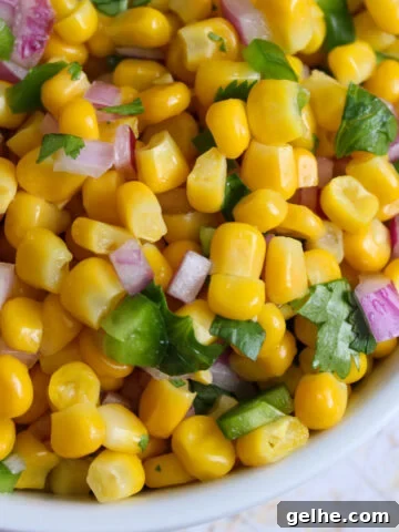 Close up of a bowl of corn, jalapeño, and onion in a bowl.