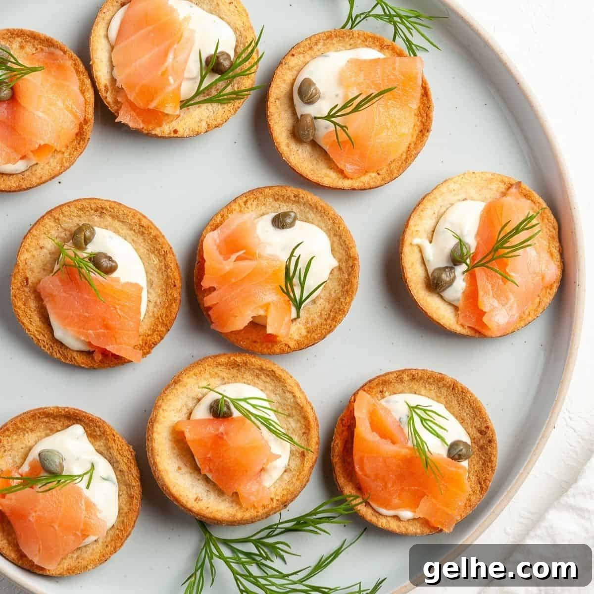 Round plate with canapés, garnished with some dill leaves.