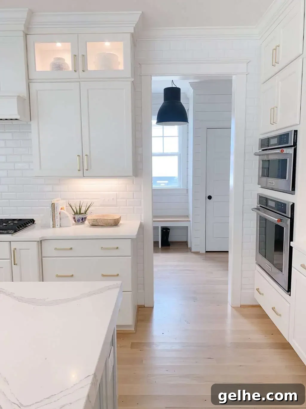 White Oak Flooring Guide: Types, Pros, Installation & Care 5 subway tile in a blue and white kitchen