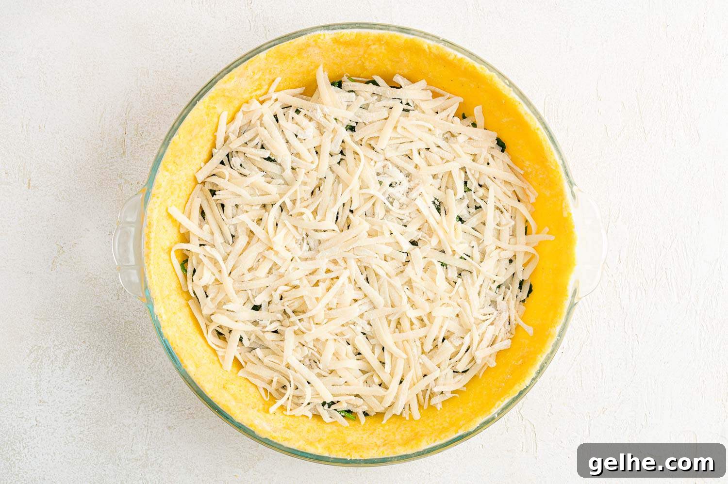 Cheese added on top of spinach.