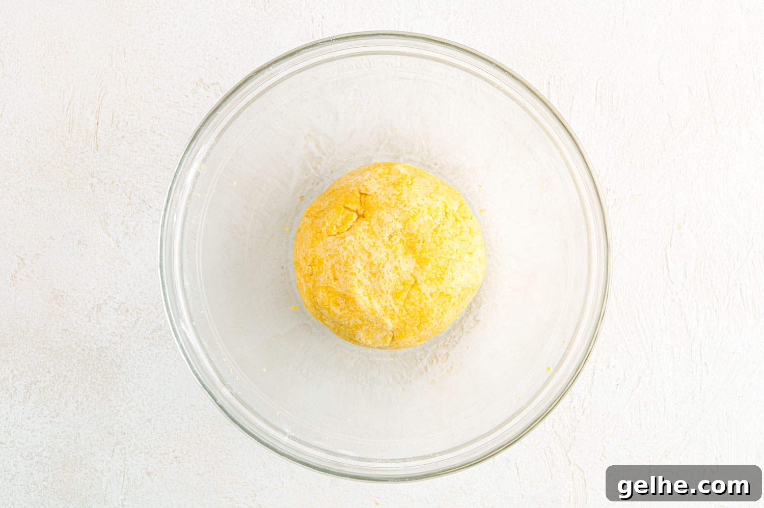 Crust formed into a smooth ball, yellow in color.