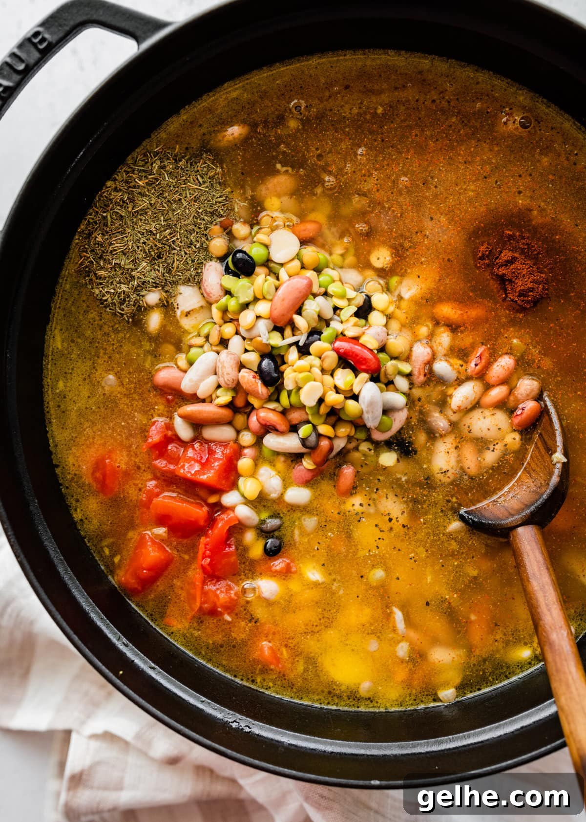 how to make 15 bean soup mix recipe with ham Step by Step: adding beans, spices, and tomatoes to the pot.