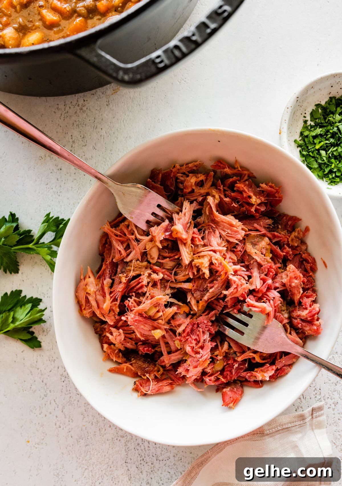 how to make 15 bean soup mix recipe with ham Step by Step: taking out the ham from the ham hock and shredding it in a separate bowl.