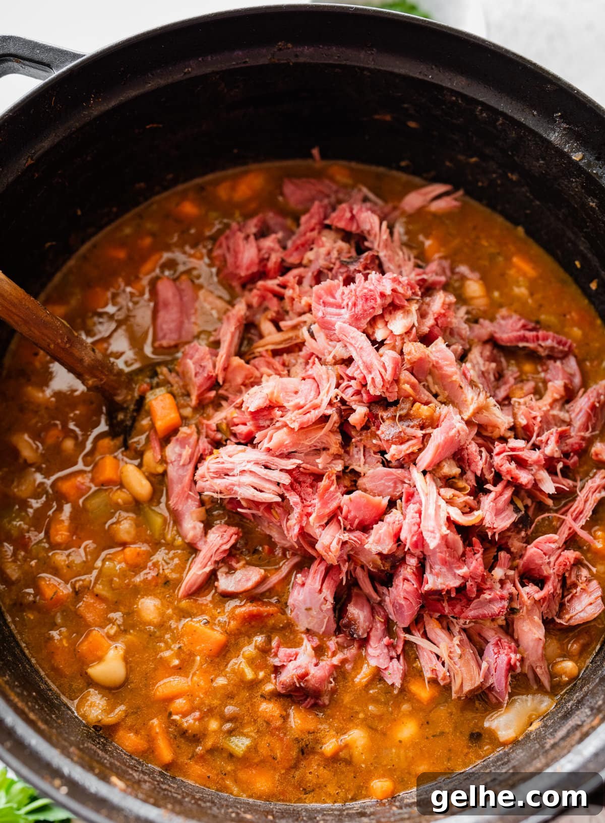 how to make 15 bean soup mix recipe with ham Step by Step: adding the shredded ham back into the pot of soup.