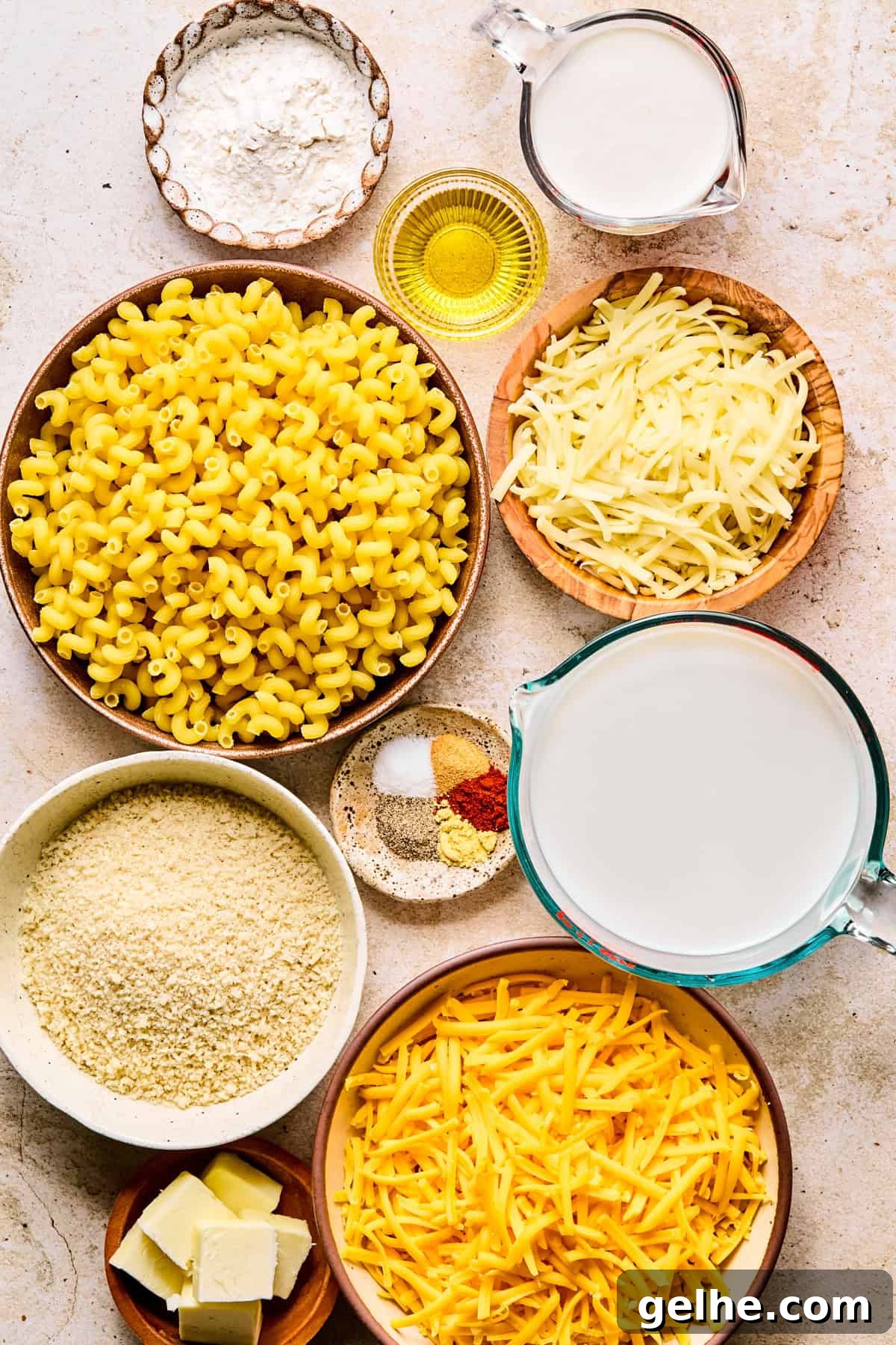 Pasta, shredded cheese, milk and other ingredients to make recipe.