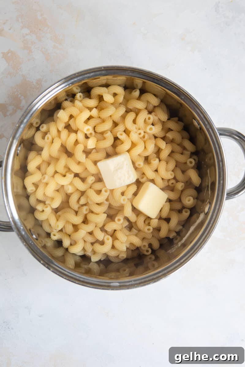 Pot with cooked pasta and butter.