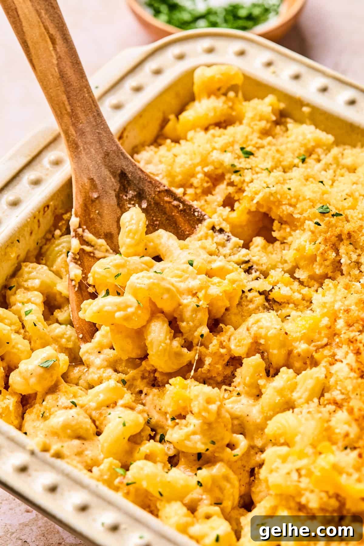 Pan of baked mac and cheese with serving spoon.