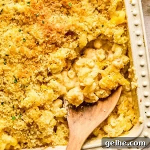 Macaroni and cheese in pan baked with breadcrumbs and chopped parsley on top.