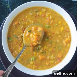 Spoonful of soup being lifted from a bowl.