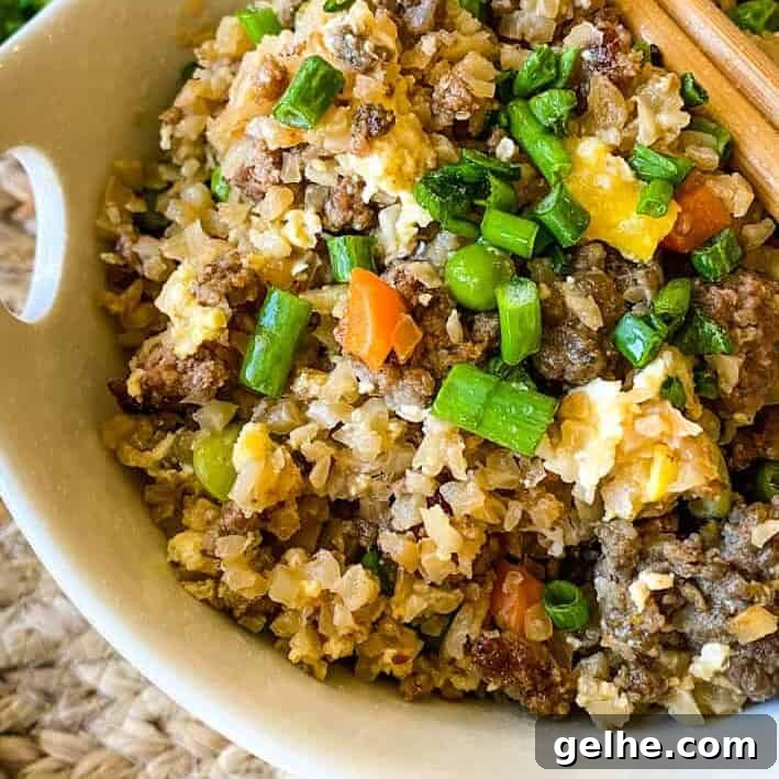 Close up of a bowl of fried rice with mixed veggies