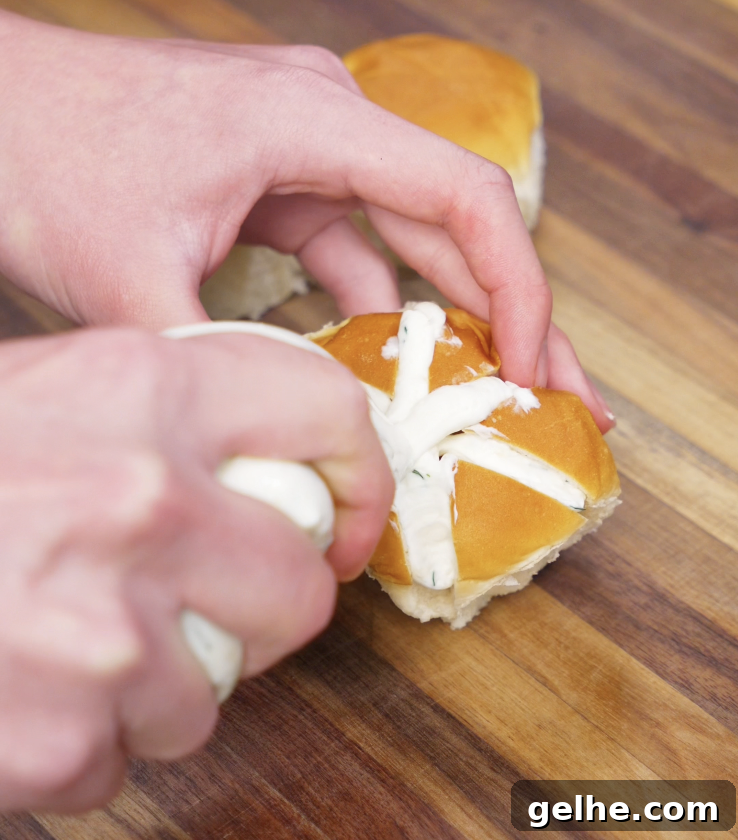 Korean Garlic Cheese Bread Recipe — Crispy, Cheesy Garlic Pull-Apart 7 Cream cheese filling is piped into the deep slits of the bread roll using a ziploc bag, creating the signature cross pattern.