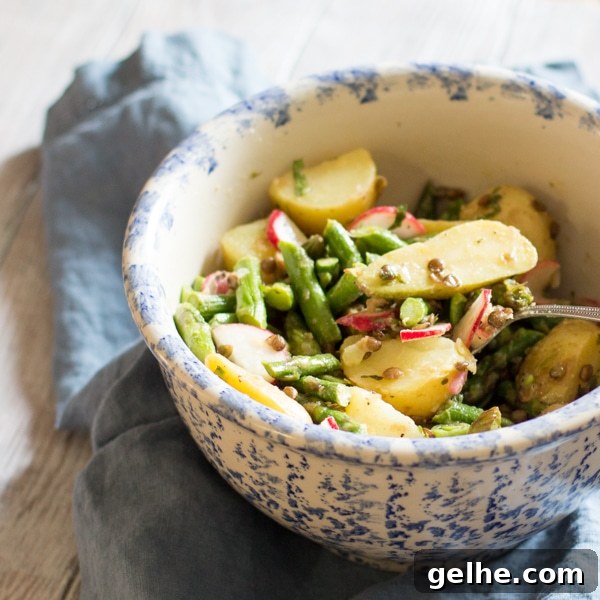 17 Delicious Vegetarian Easter Dinner Ideas for a Memorable Feast 11 A bowl filled with asparagus salad with Yukon potatoes, radishes and lentils. The salad is tossed in a lemon vinaigrette.