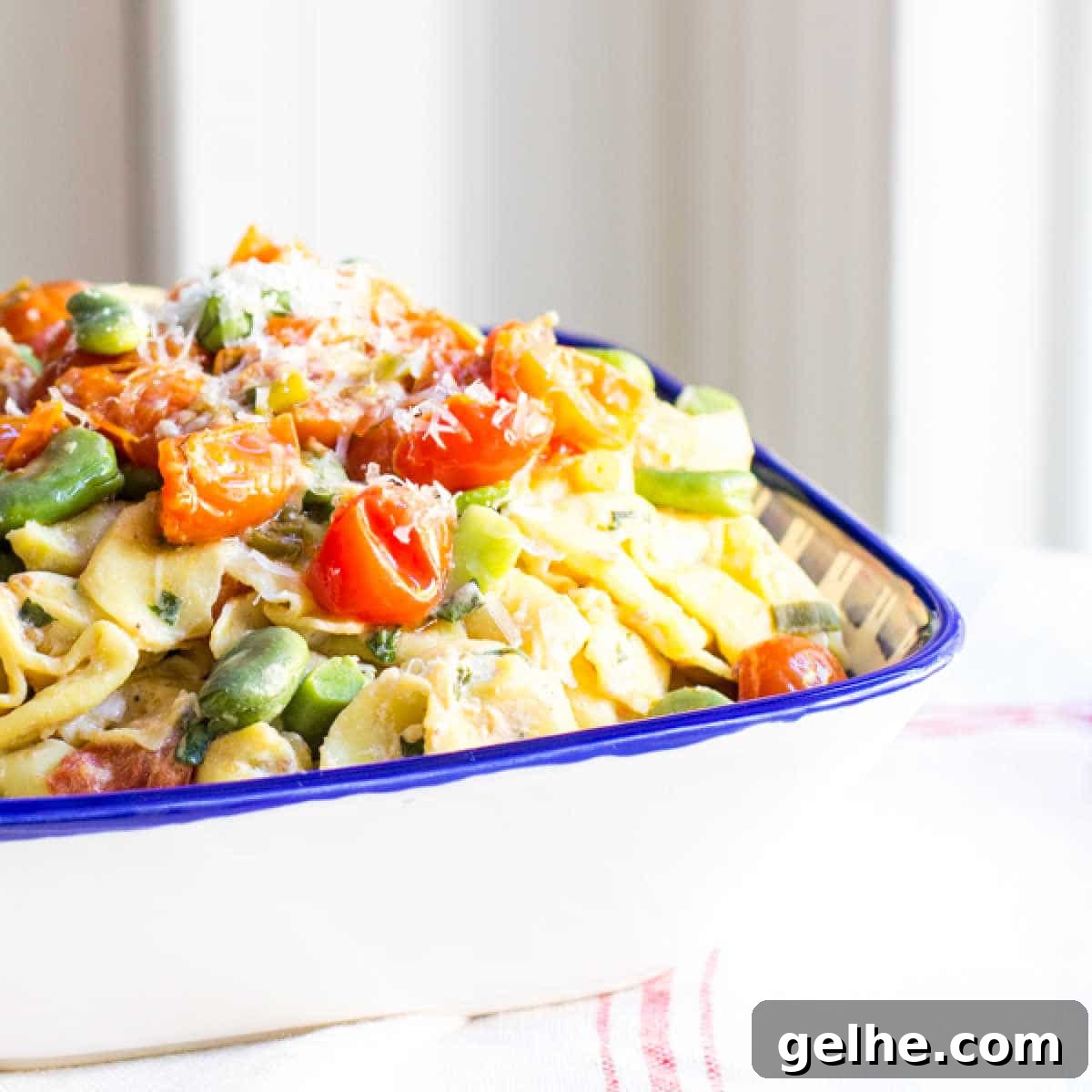 17 Delicious Vegetarian Easter Dinner Ideas for a Memorable Feast 16 A bowl of tortellini pasta tossed with fava beans, tomatoes and herbed ricotta cheese.