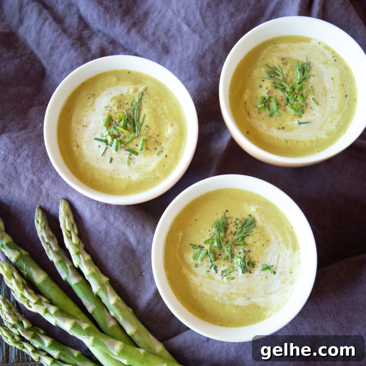 17 Delicious Vegetarian Easter Dinner Ideas for a Memorable Feast 5 3 bowls of cream of asparagus soup, garnished with chives and fresh dill. A few asparagus are off to the side.