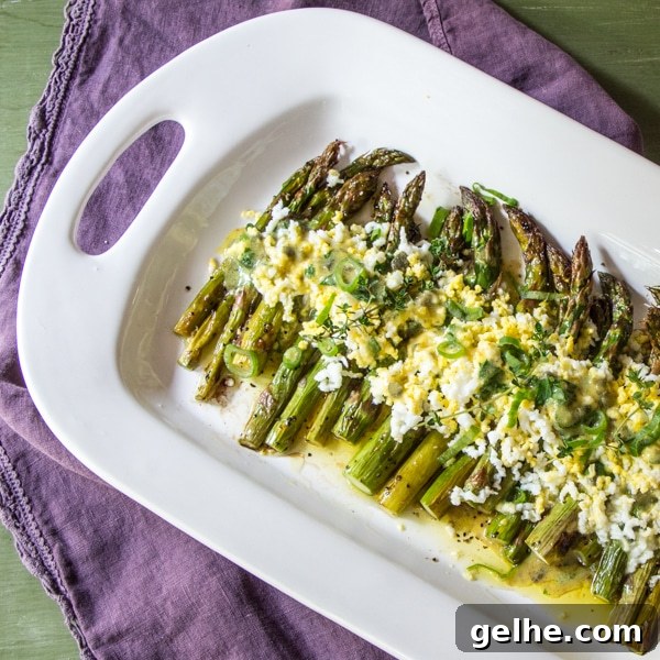 17 Delicious Vegetarian Easter Dinner Ideas for a Memorable Feast 8 A serving tray of roasted asparagus, topped with a gribiche sauce.