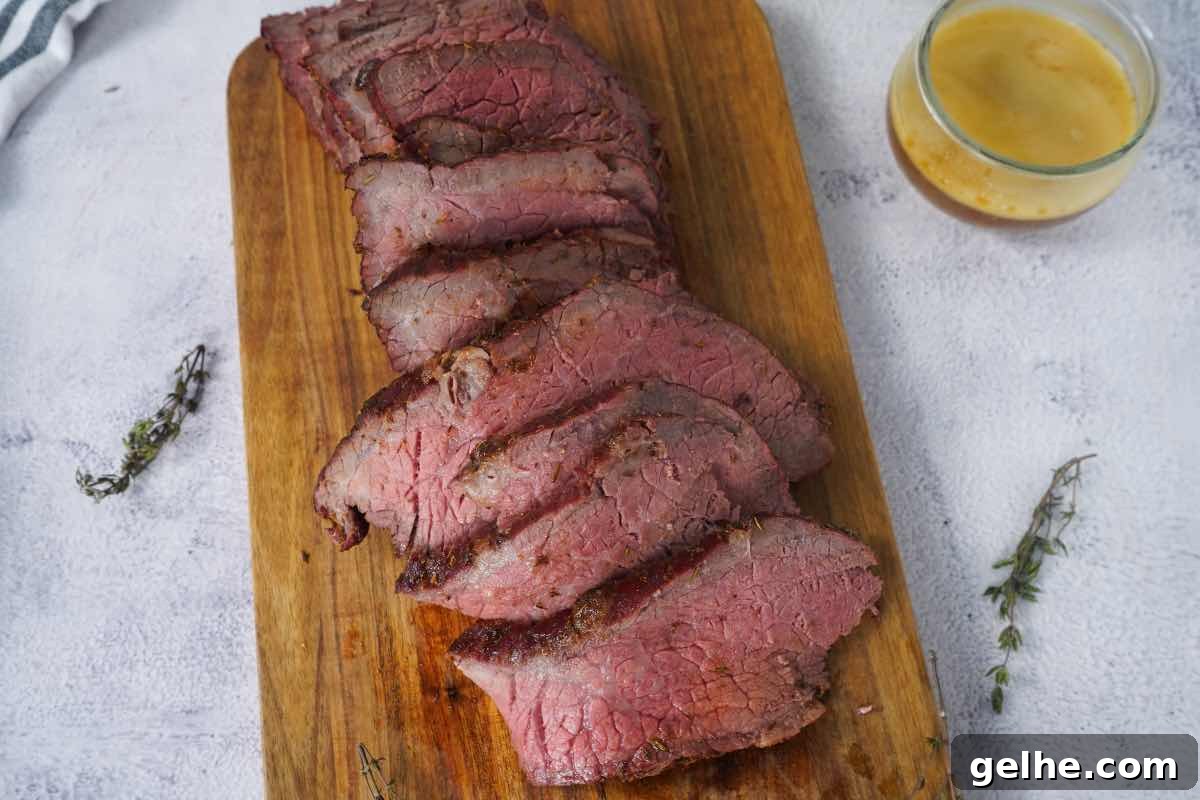 Smoked rump roast sliced with sprigs of thyme.