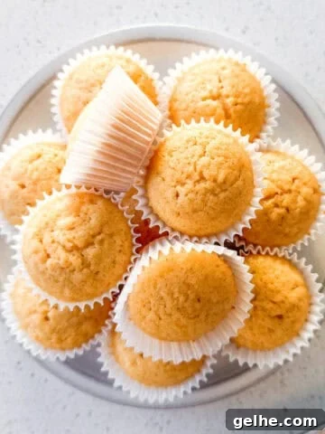 Mini honey muffins stacked on a plate.