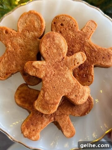Gingerbread man pancakes on a plate.
