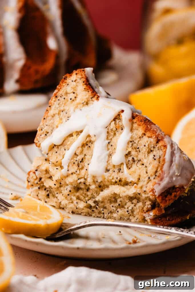 Moist Lemon Poppy Seed Bundt Cake Recipe with Zesty Glaze 12 A slice of the lemon poppyseed bundt cake on a plate, with bites missing.