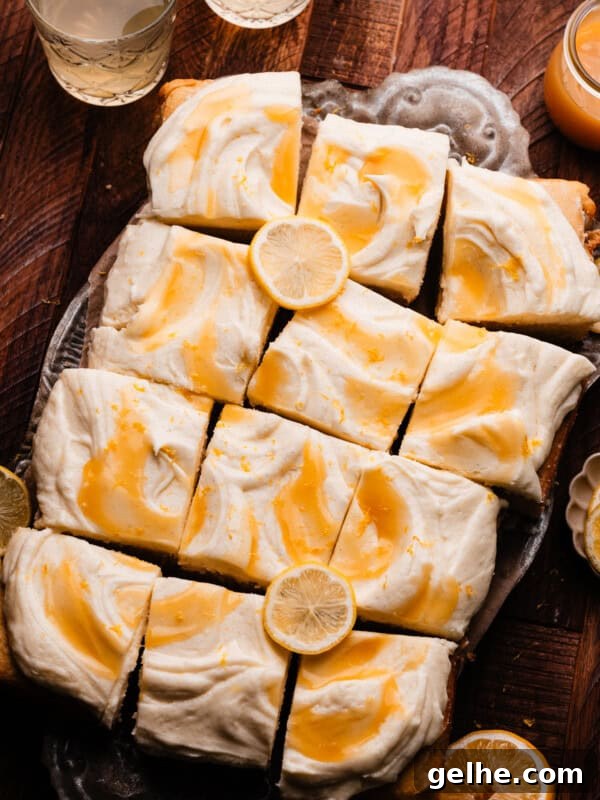 The sliced lemon curd cake on a vintage tray, topped with swirls of lemon curd.