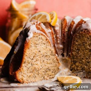 The sliced lemon poppyseed bundt cake on a cake plate.