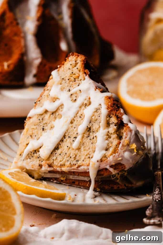 Moist Lemon Poppy Seed Bundt Cake Recipe with Zesty Glaze 3 A slice of lemon bundt cake on a plate, with extra glaze drizzled over the slice.