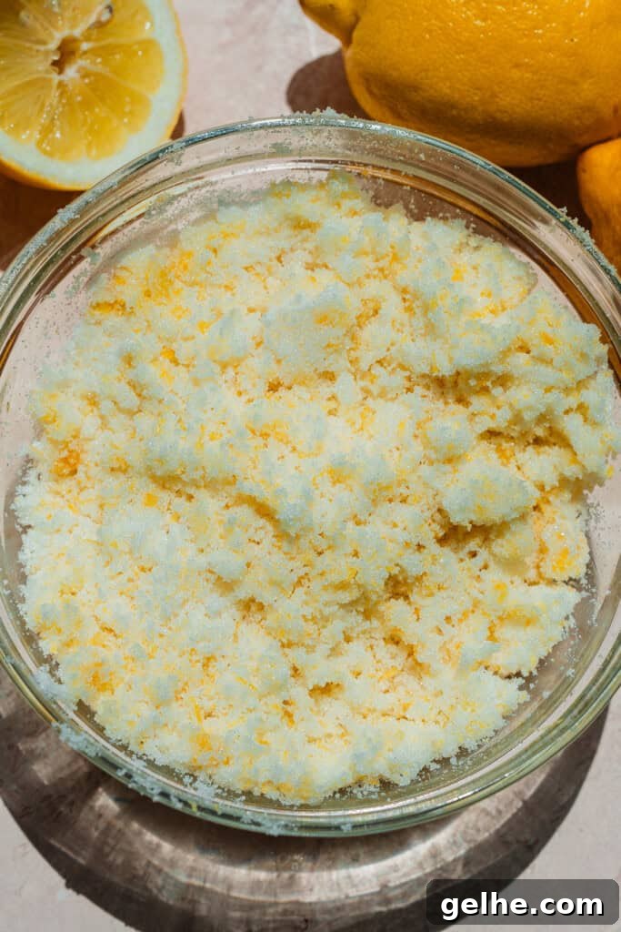 Moist Lemon Poppy Seed Bundt Cake Recipe with Zesty Glaze 5 A bowl of lemon zest rubbed into granulated sugar.