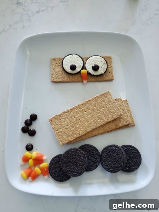 Graham Cracker Owl Treats — Step-by-Step Video Tutorial 3 graham crackers, oreos, candy corn and M&Ms on a white plate