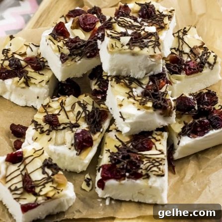 Toasted Almond Cranberry Bark Recipe with Step-by-Step Photos 2 WW completed toasted almond cranberry yogurt bark pieces stacked on a sheet of parchment paper.